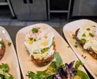 a plate of food with an egg sandwich and a salad at The Old Schoolhouse Hotel in Larkhall