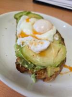 a sandwich with eggs and avocado on a white plate at The Old Schoolhouse Hotel in Larkhall