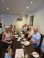 a group of people sitting around a table at The Old Schoolhouse Hotel in Larkhall
