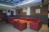 a conference room with red chairs and a wooden table at Hotel Horizon Plaza in Gwalior