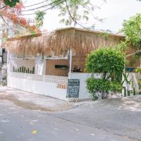 een gebouw met een rieten dak met een bord vooraan bij Bougenvilla Nusa Dua Villa with Private Pool in Nusa Dua