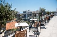 a row of tables and chairs on a balcony at Rise Urban Art Hotel in Larnaka