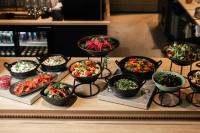 a table topped with bowls of different types of food at Lapland Winter Park Chalets in Rovaniemi