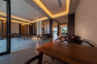 a dining room with tables and chairs and windows at 诺亚度假酒店 in Luang Prabang