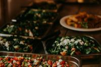 a table with trays of pizzas and a plate of food at Best Western Hotel Trollhattan in Trollhättan
