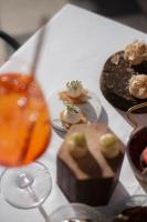 a table with plates of food and a wine glass at Hotel Villa La Bollina in Serravalle Scrivia