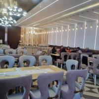 ein Zimmer mit Tischen und Stühlen sowie Tischen in der Unterkunft Clarissa Resort, Mukteshwar in Mukteswar