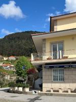 a building with a balcony on the side of it at Quarto Familiar do Januário in Bilhó