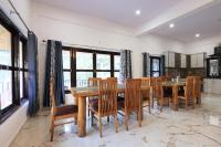 a dining room with a wooden table and chairs at Nature Roar Forest Resort ,Nainital in Nainital