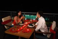 a man and woman sitting at a table with wine glasses at SILA - Mountain Majesty in Sakleshpur