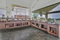 a restaurant with a counter with dishes on it at SILA - Mountain Majesty in Sakleshpur