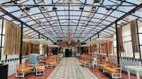 a large room with chairs and a glass ceiling at Hotel The Pearl in Rourkela