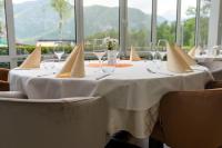 a table with glasses and napkins on top at Hotel Jezero in Bohinj