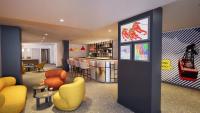 a hotel lobby with a bar and chairs and a counter at PopAlp la Plagne - Hôtel et Restaurant in La Plagne Tarentaise