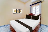 a bedroom with a large white bed and a window at Super Collection O Madurai Theni Road in Sakkanurani
