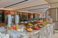 a buffet line with many different types of food at Hyatt Place Kunshan Gaoxin in Kunshan