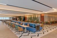 a restaurant with a row of tables and chairs at Hyatt Place Kunshan Gaoxin in Kunshan