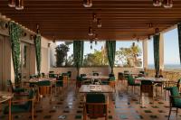 a restaurant with tables and chairs and large windows at VISTA Ostuni in Ostuni