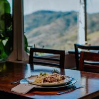 a plate of food sitting on a table at Hotel Pousada Shangri-la in Serra Negra
