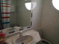 a bathroom with a sink and a mirror and a toilet at Hotel San Jorge in Alcalá de los Gazules