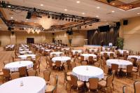 a banquet hall with tables and chairs and a stage at Harrah's Lake Tahoe Hotel & Casino in Stateline