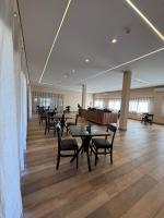 a dining room with tables and chairs in a building at Pousada Maritaca in Bonito