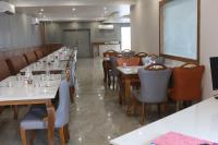 a dining room with long tables and chairs at Soil to Soul Trinity Hotel - A Boutique Stay in Somnath