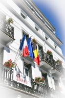 a building with flags on the side of it at Hôtel Panoramic in Luchon