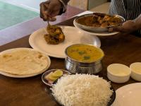 una mesa cubierta con platos de comida y arroz en Hotel Dwaraka, en Thane