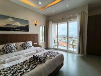 Ένα ή περισσότερα κρεβάτια σε δωμάτιο στο Kynjing Suites