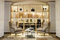 two chairs and a table in a room with shelves at Midtown Boutique Hotel in Buenos Aires