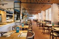 a dining room with wooden tables and chairs at Grupotel Cala Marsal Nature Hotel in Portocolom