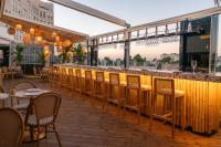 a restaurant with a bar with chairs and tables at Agripas Boutique Hotel in Jerusalem