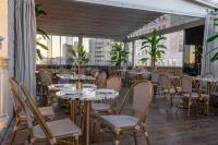 a restaurant with tables and chairs on a balcony at Agripas Boutique Hotel in Jerusalem