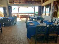 a dining room with blue tables and chairs at Casa de las Olas Surf & Beach Club in Acapulco
