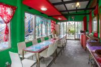 a dining room with green walls and a table and chairs at Chenyuan B&amp;B in Ji&#39;an