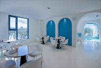 a restaurant with white tables and chairs and blue walls at Dali Canghaixueyue Seaview Hotel in Dali