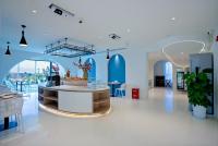 a room with blue walls and a table and chairs at Dali Canghaixueyue Seaview Hotel in Dali