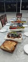 een lange tafel met verschillende borden voedsel erop bij Events Park Qebele in Gabala