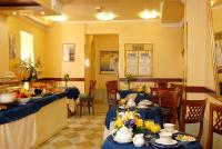a restaurant with blue tables and chairs with food at Hotel Ca&#39; Formenta in Venice