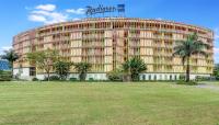 キガリにあるRadisson Blu Hotel &amp; Convention Centre Kigaliのヤシの木が前に生えている大きな建物
