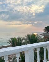 a view of the ocean from the balcony of a resort at Wadi shab Beach Resort in Sur