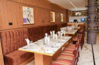 a dining room with long tables and chairs at Humble Citadel Hotel in Lagos
