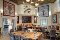 a dining room with wooden tables and chairs at Dollywood's DreamMore Resort and Spa in Pigeon Forge