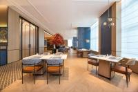 a restaurant with tables and chairs in a room at Four Points by Sheraton Nanning, Wuxiang in Nanning