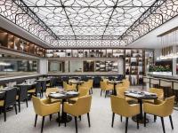 a restaurant with tables and chairs and a ceiling at St. Regis Macao in Macau