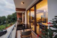 a balcony of a house with a car in the window at Ikabane in Agapia