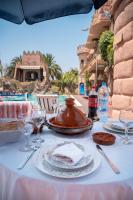 a table with plates of food and wine glasses at Lakala Complexe Touristique in O Ben Slimane