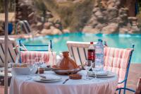 a table with glasses and bottles of water on it at Lakala Complexe Touristique in O Ben Slimane