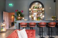 a bar with red chairs and a red couch at Number 59 Dublin in Dublin